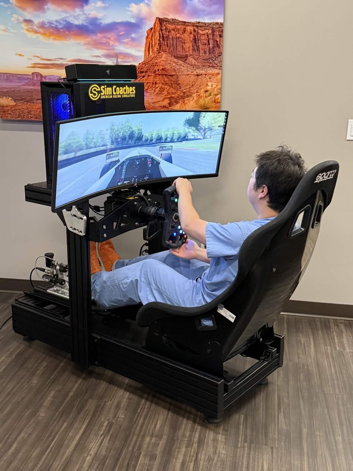 Guests using Orion racing simulators at a live event